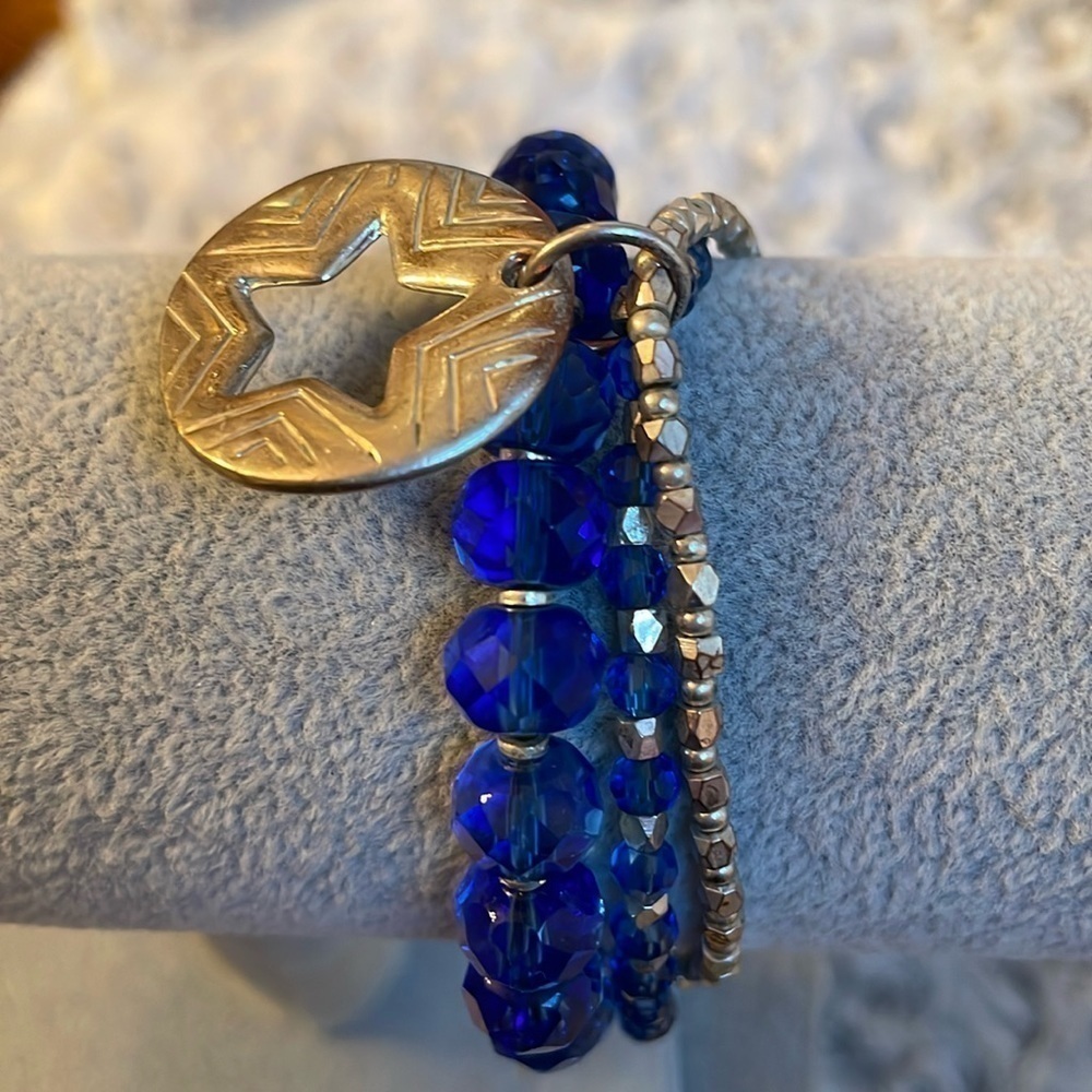 Set of 3 connected blue and silver jewel like bracelets with a star charm.